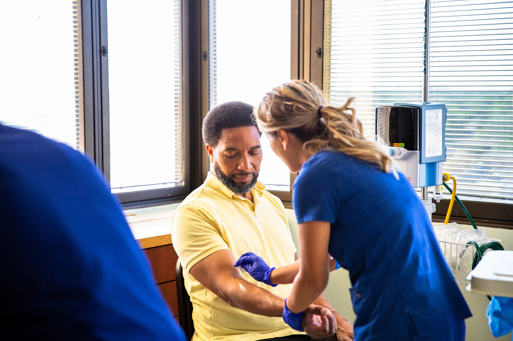a man being prepped for a blood test by a nurse