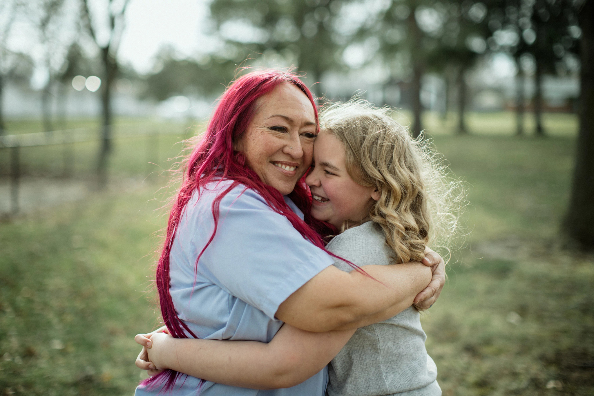 Mail carrier Rungphet Bodnar hugs Chloe Shanks, the girl she saved from a dog attack