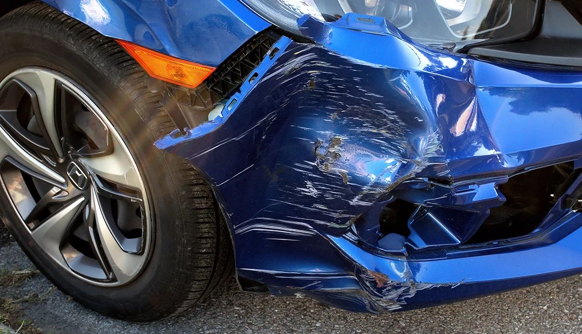 a blue car with heavy body damage