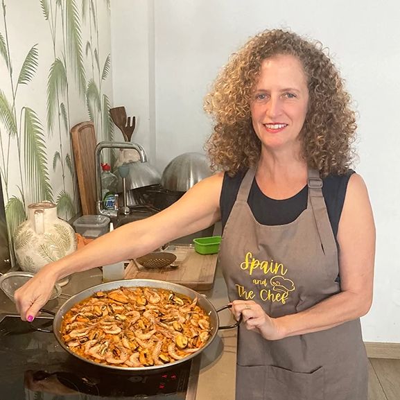 Aileen Weintraub cooking Aileen Weintraub with a pan of paella