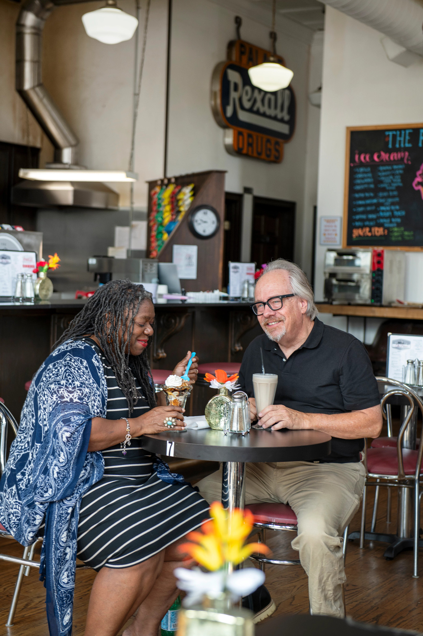 Jennifer and Lynn O'Connell sitting at table, eating ice cream