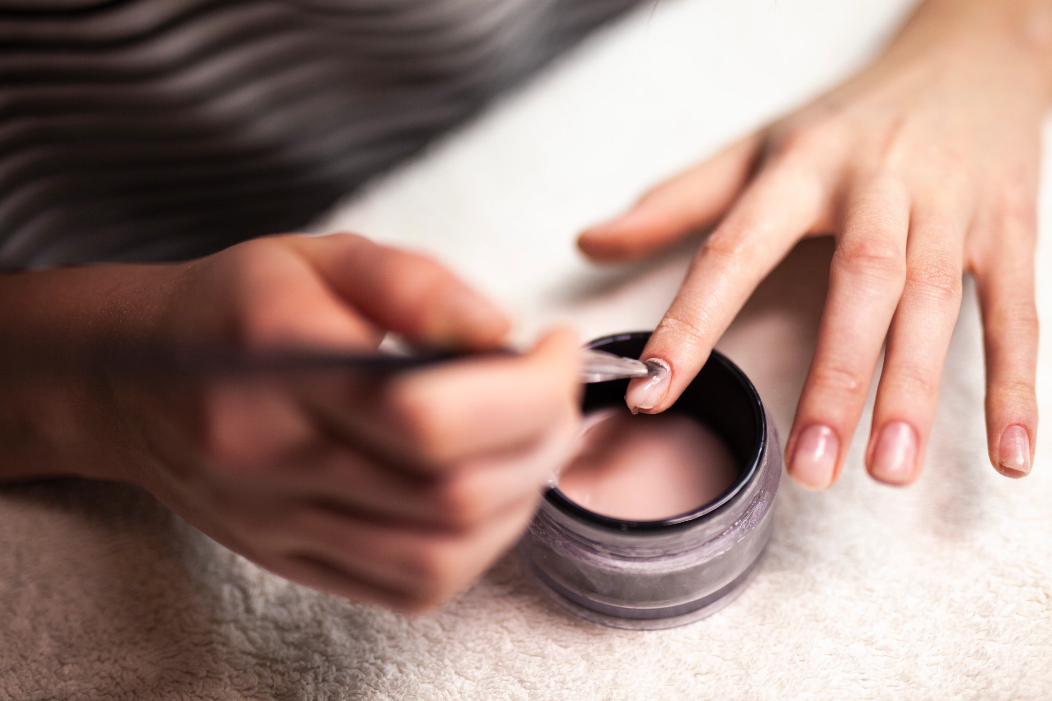 A woman painting her nails