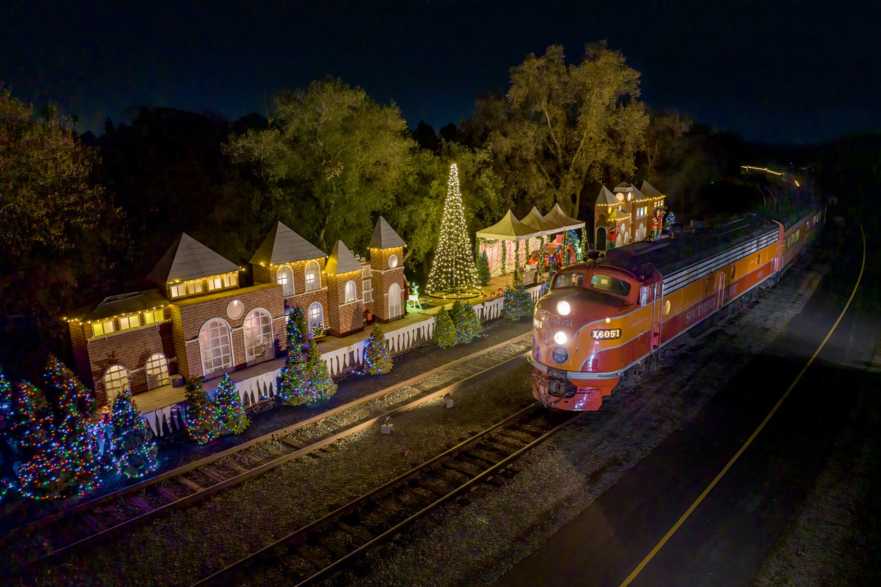 a train traveling past a festive train station