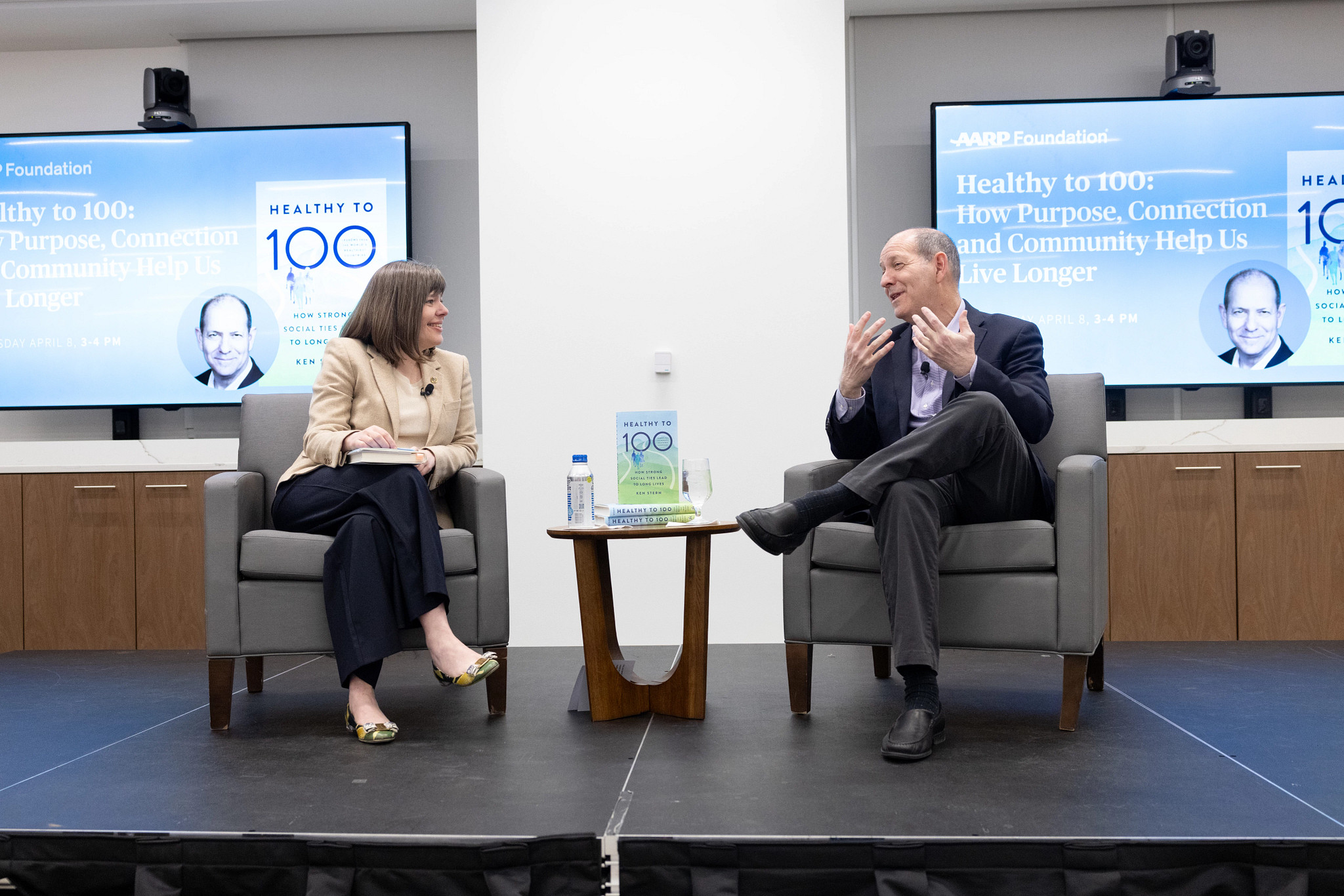 AARP Foundation President Claire Casey talking with "Healthy to 100" author Ken Stern