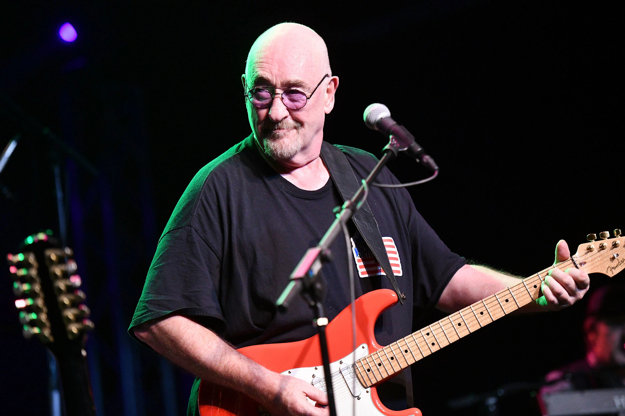 dave mason performing onstage with his guitar