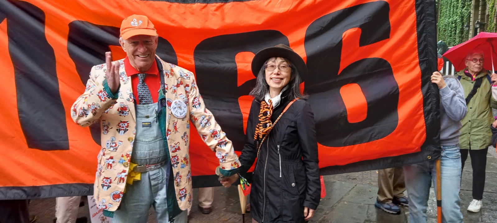 Author T.R. Reid and Sachiko Nakahira stand in front of a Class of ’66 banner at the Princeton reunion parade