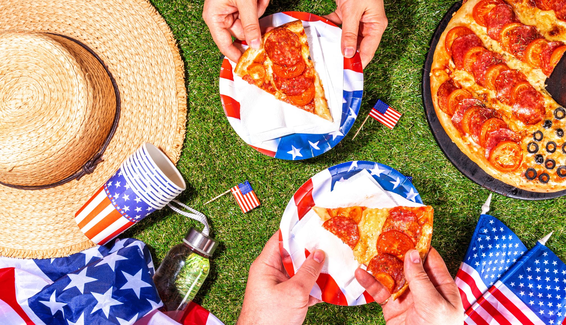 July 4 deals pizza on patriotic paper plates with flags in the background