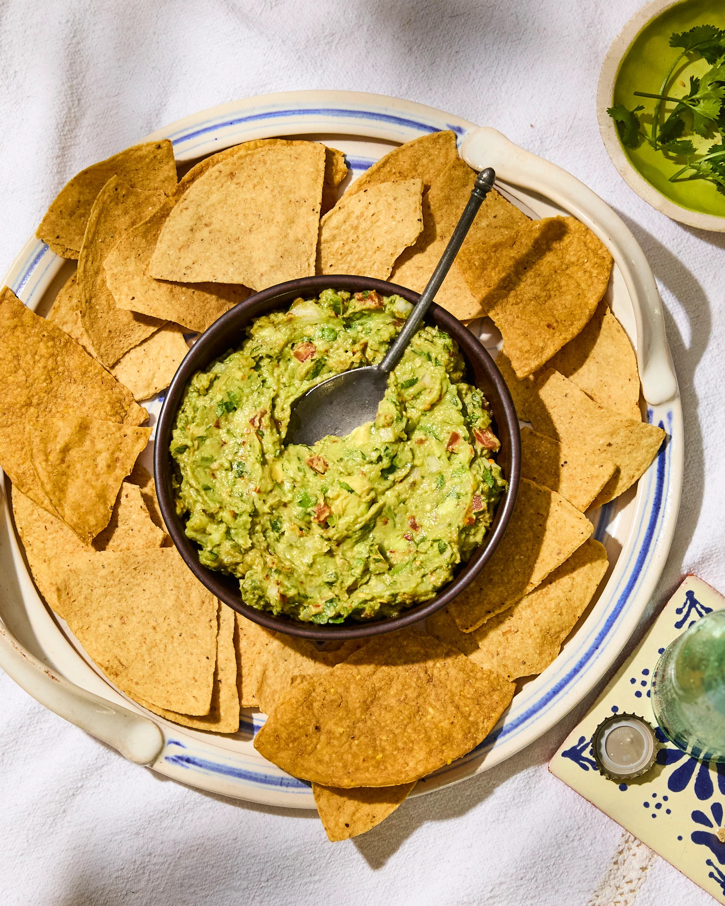 A photo shows Chile de Árbol Guacamole with Baked Corn Tortilla Chips
