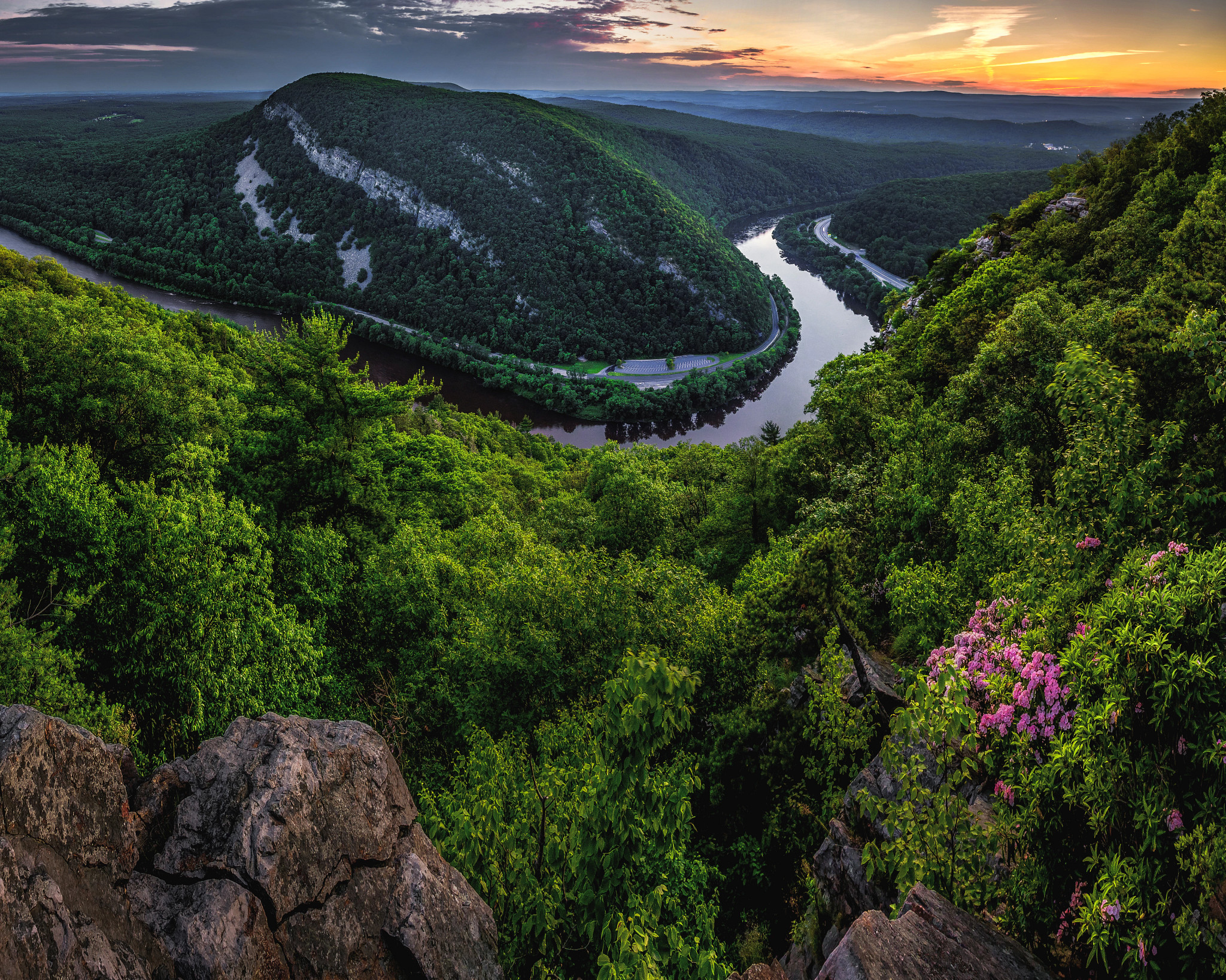 the delaware river winds through tree covered hills and mountains