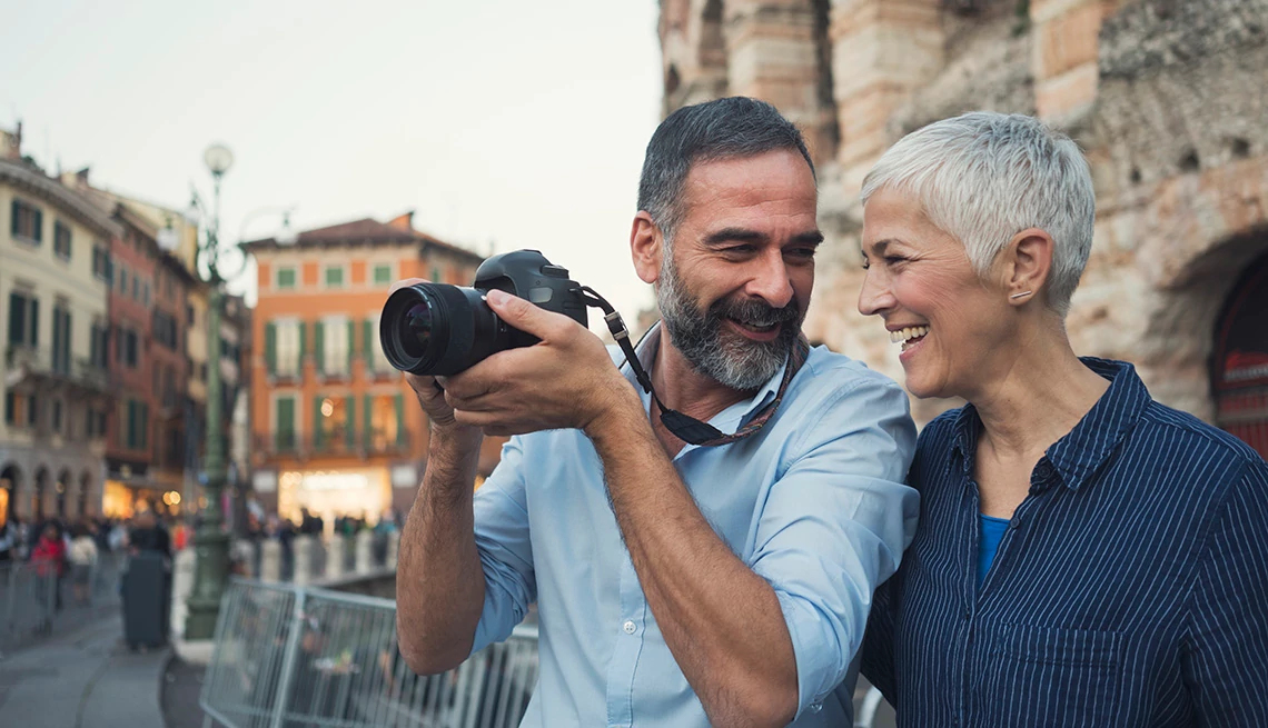 Mature couple as tourist in city Verona with camera