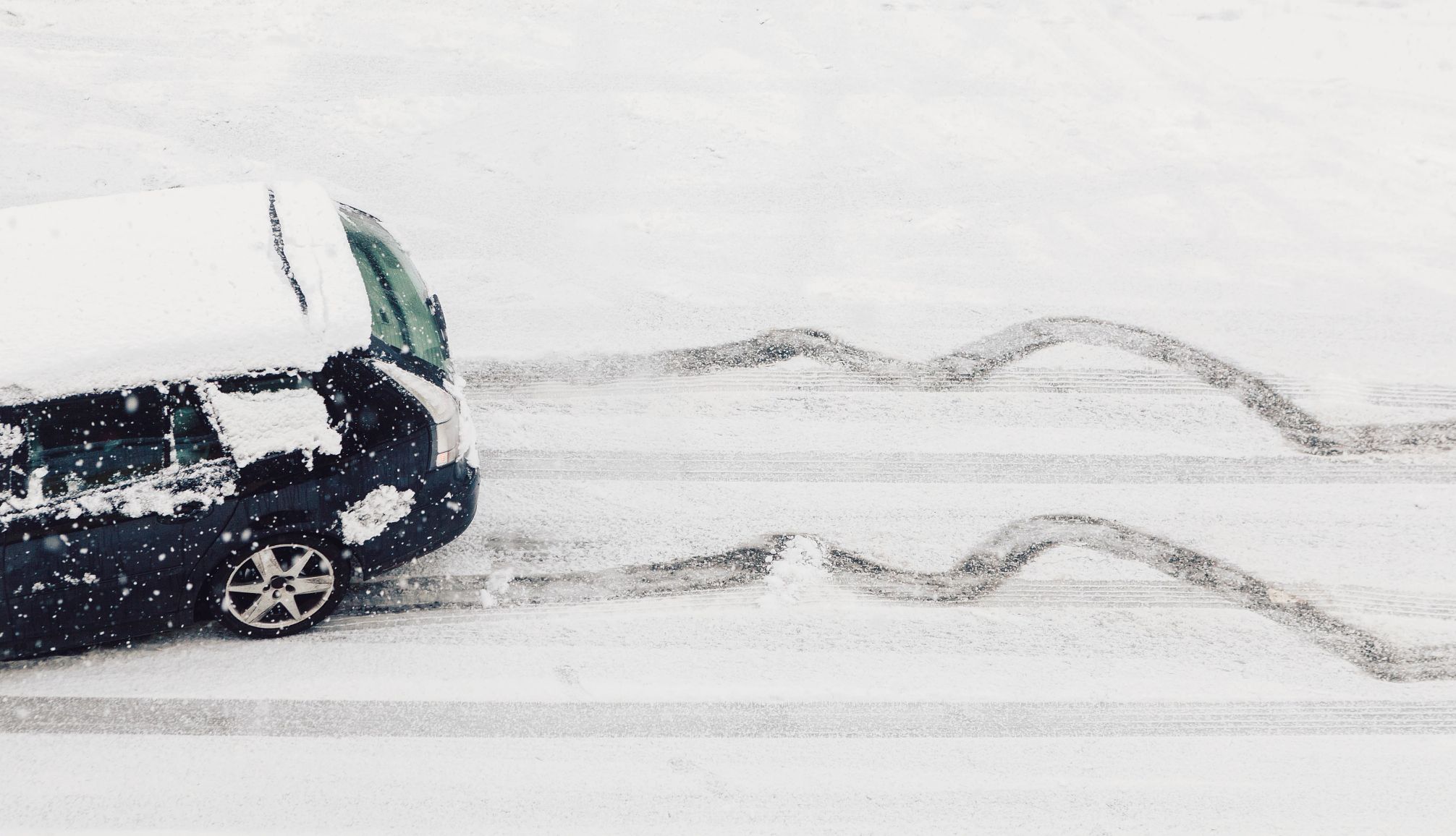 Winter Driving Tips a car skidding on an icy road