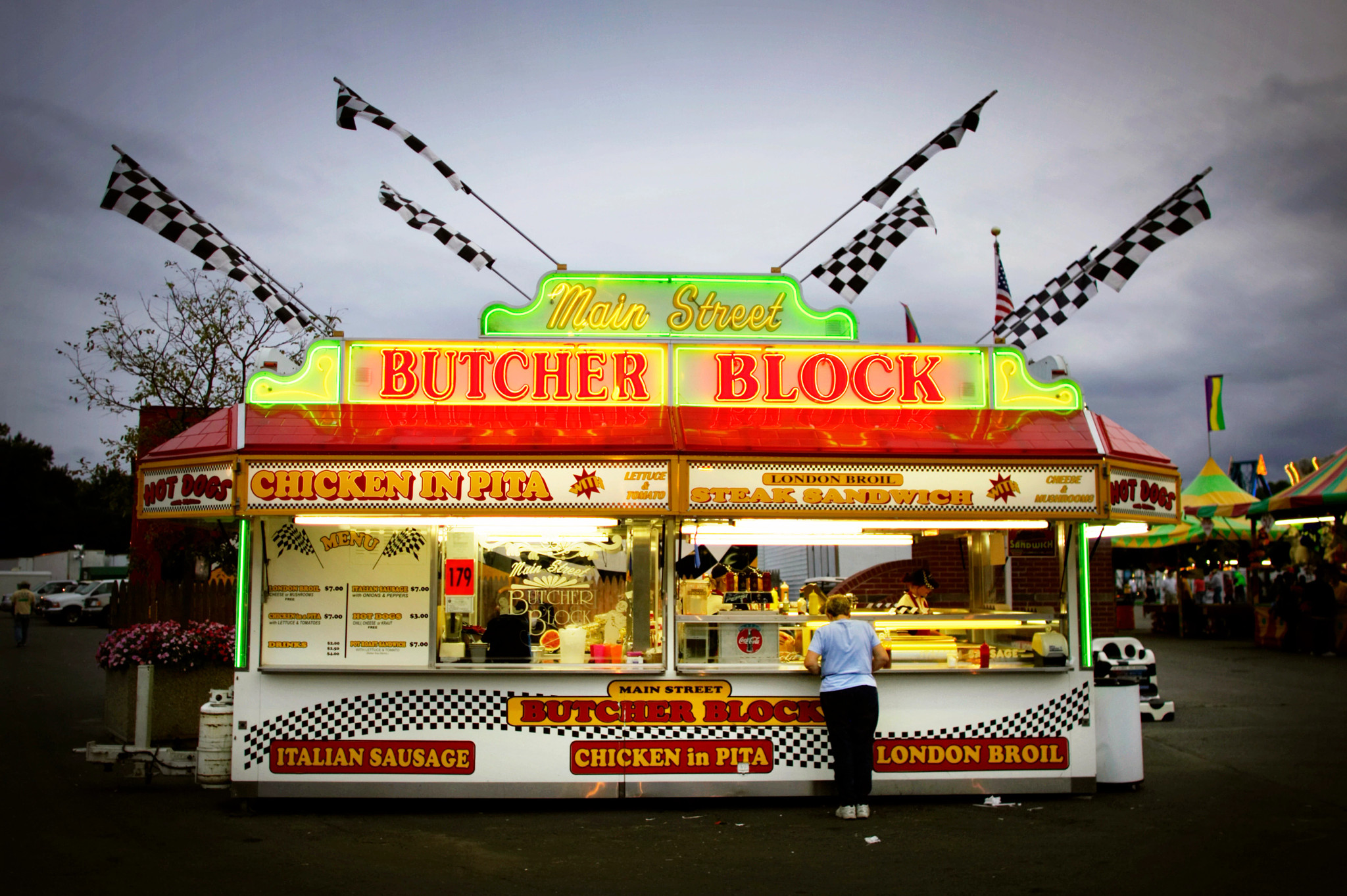 a woman buying food from a vendor at The Big E