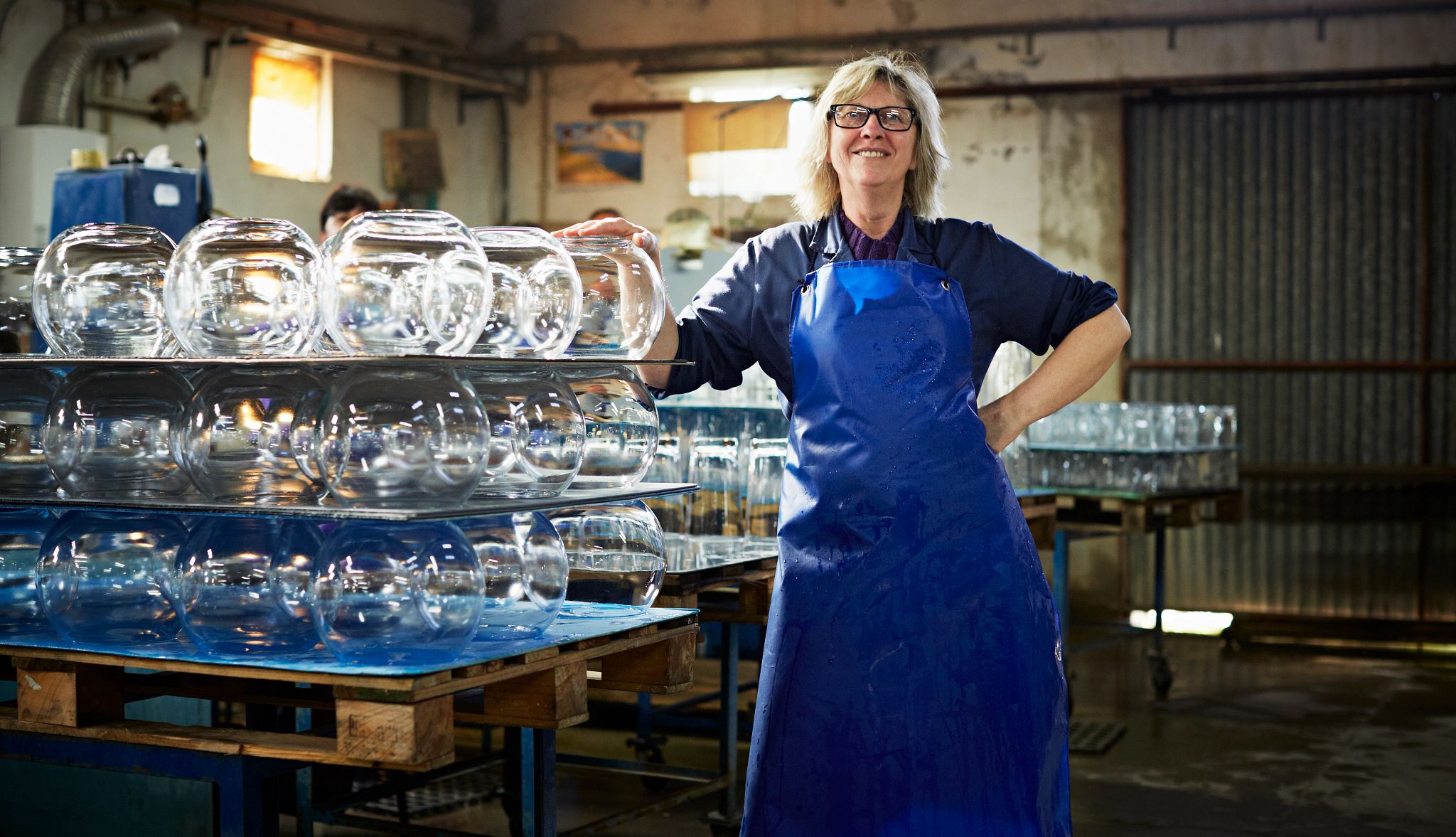 Portrait of female glass worker by finished round vases Portrait of female glass worker by finished round vases