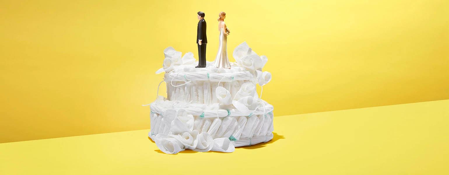 Wedding cake made out of tampons with bride and groom figurines on top.