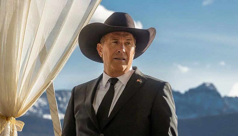 Kevin Costner in Yellowstone Kevin Costner wearing a cowboy hat and suit in a scene from the television series Yellowstone