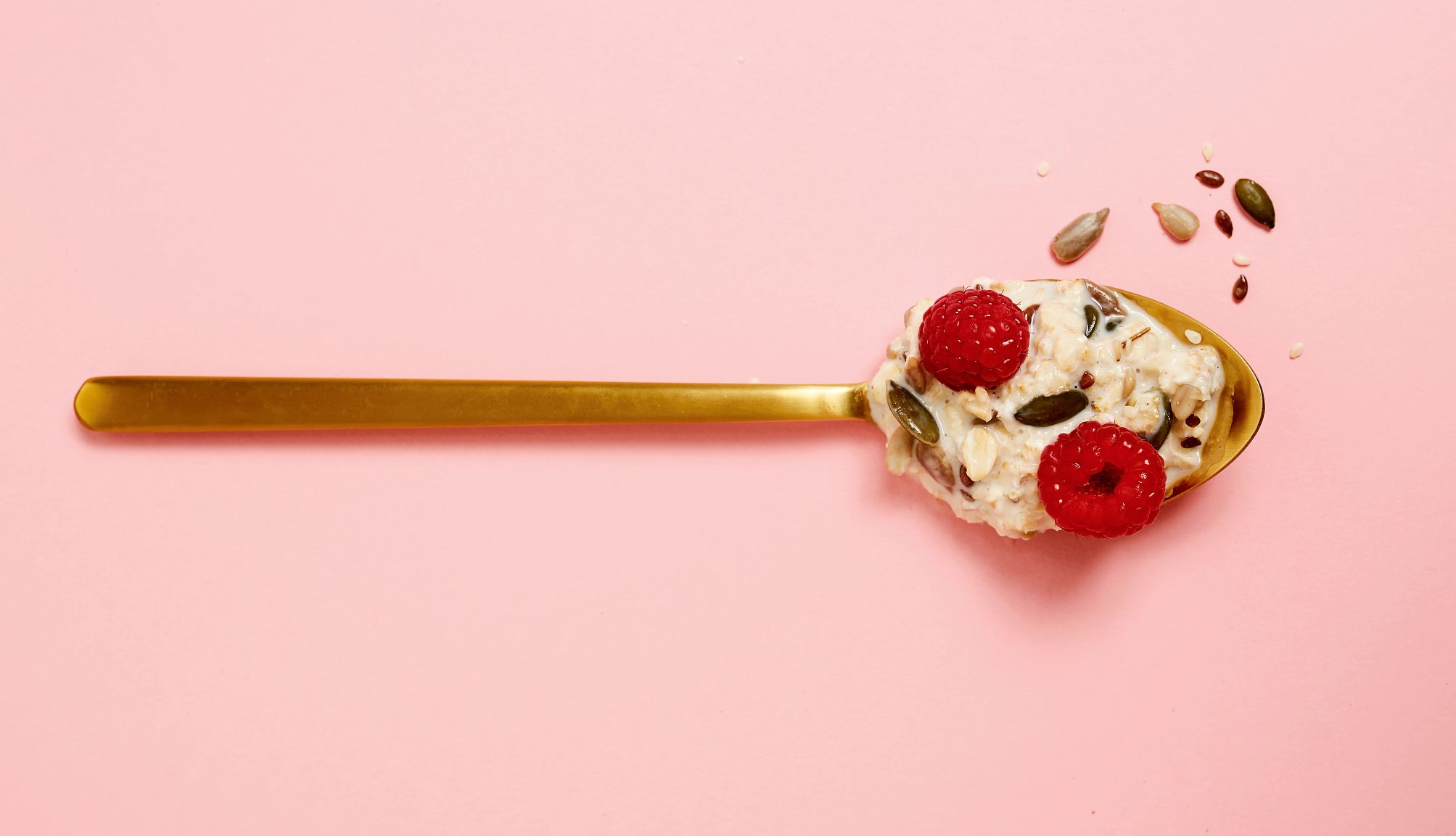 Eat More Fiber spoonful of muessli, nuts, oats, porridge, seeds and rasberries