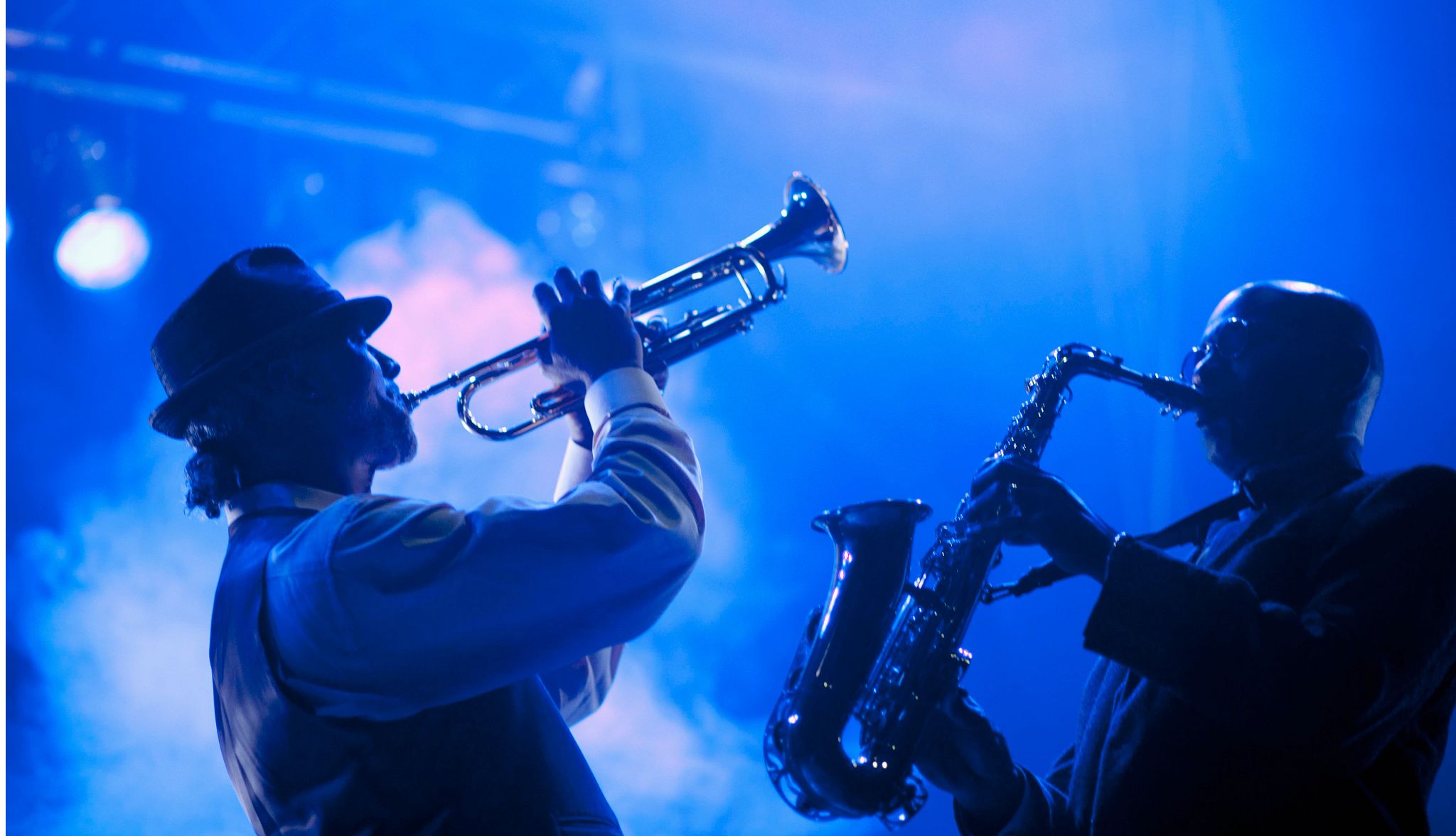 two men playing jazz on stage in the evening two men playing jazz on stage in the evening