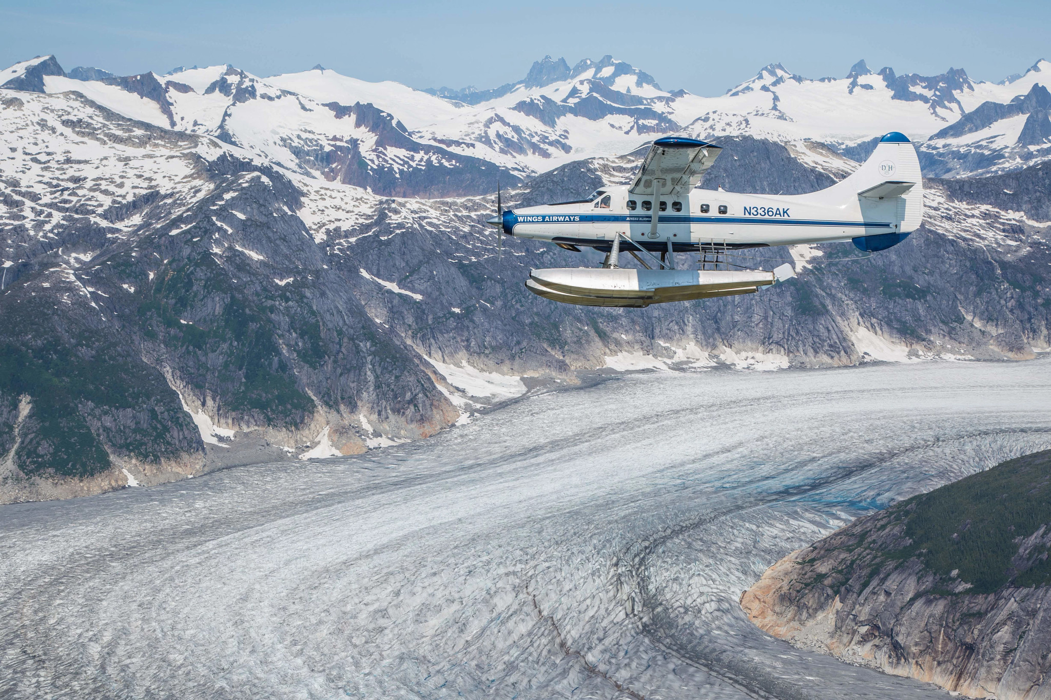 a seaplane in Alaska traveling over a mountain