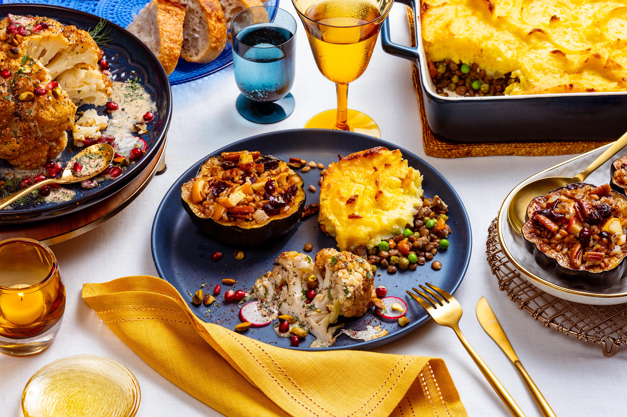 A blue plate with three delicious vegetable-based sides and surrounding serving dishes.