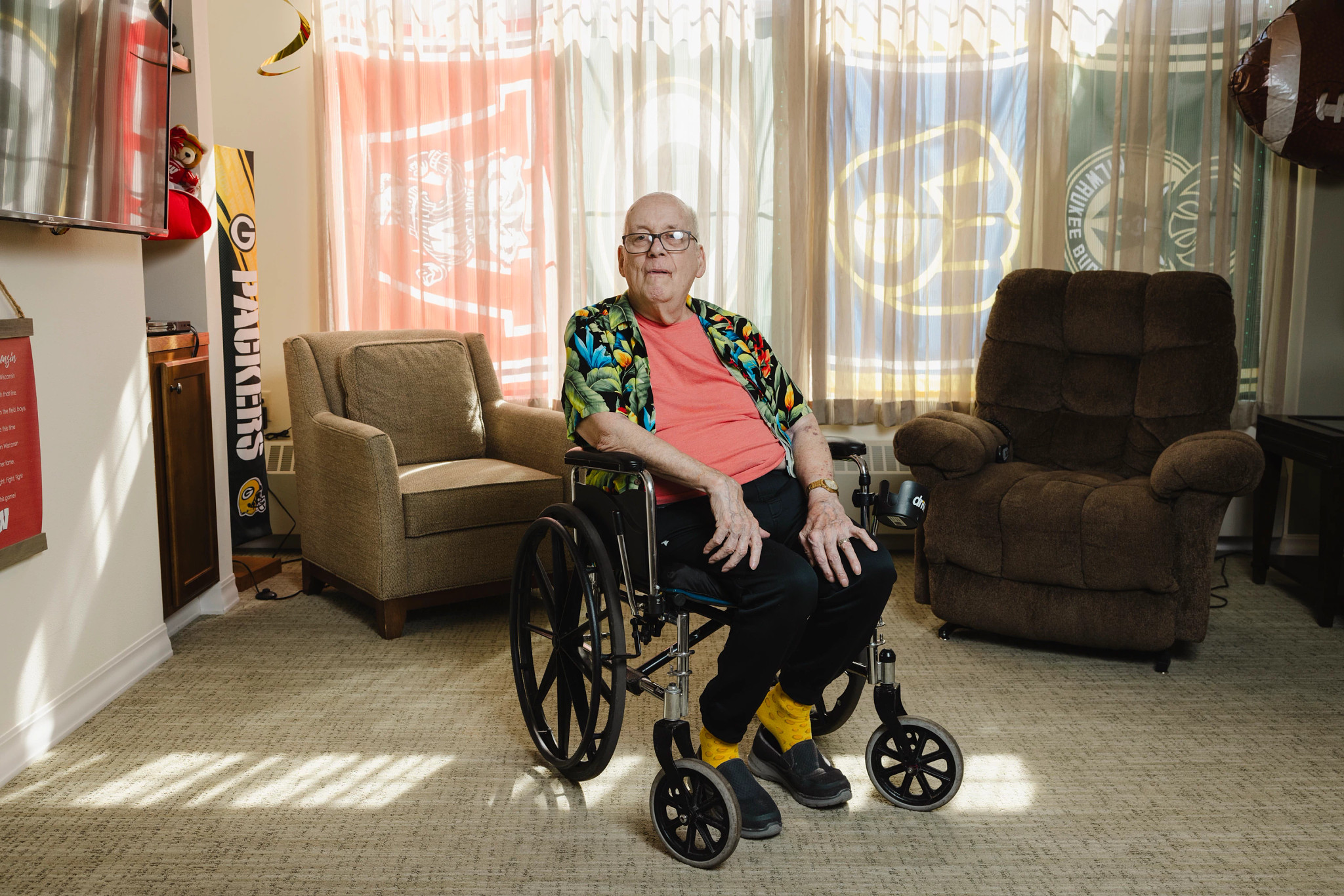 jim loersch sits in a wheelchair in his room