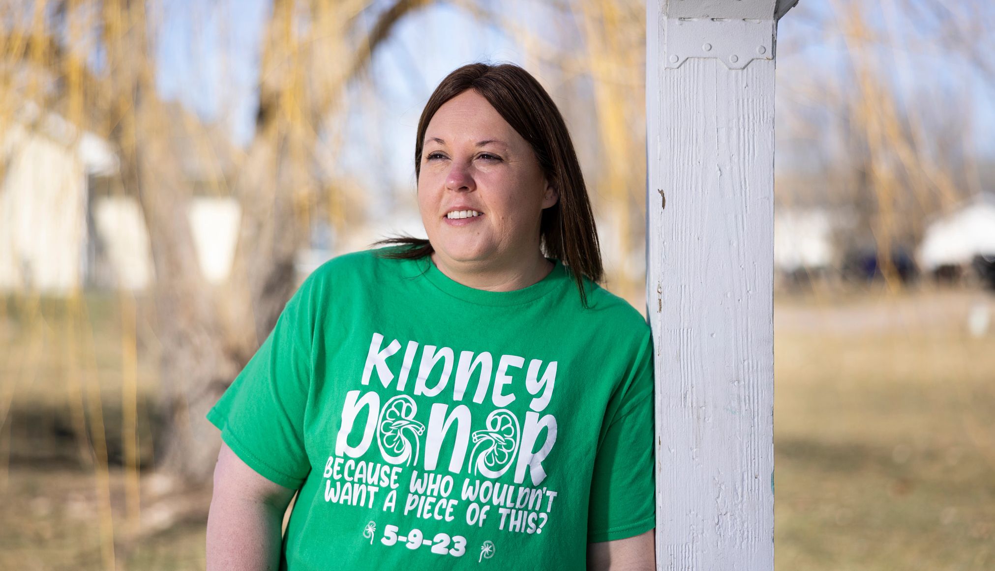 Krystal Cable outside her home Krystal Cable leaning up against pole, wearing green shirt that says kidney donor because who wouldn't want a piece of this?
