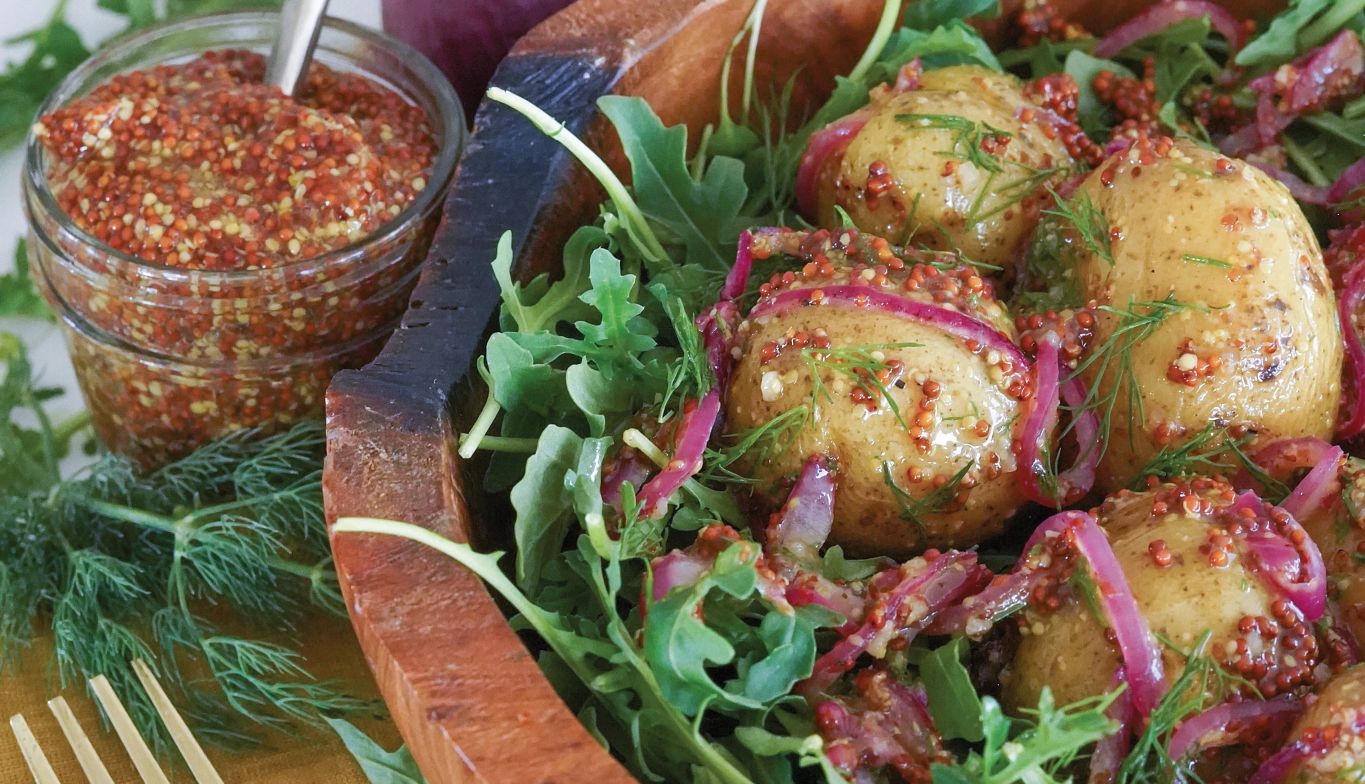 French Potato Salad Bowl Potatoes and greens in wooden bowl