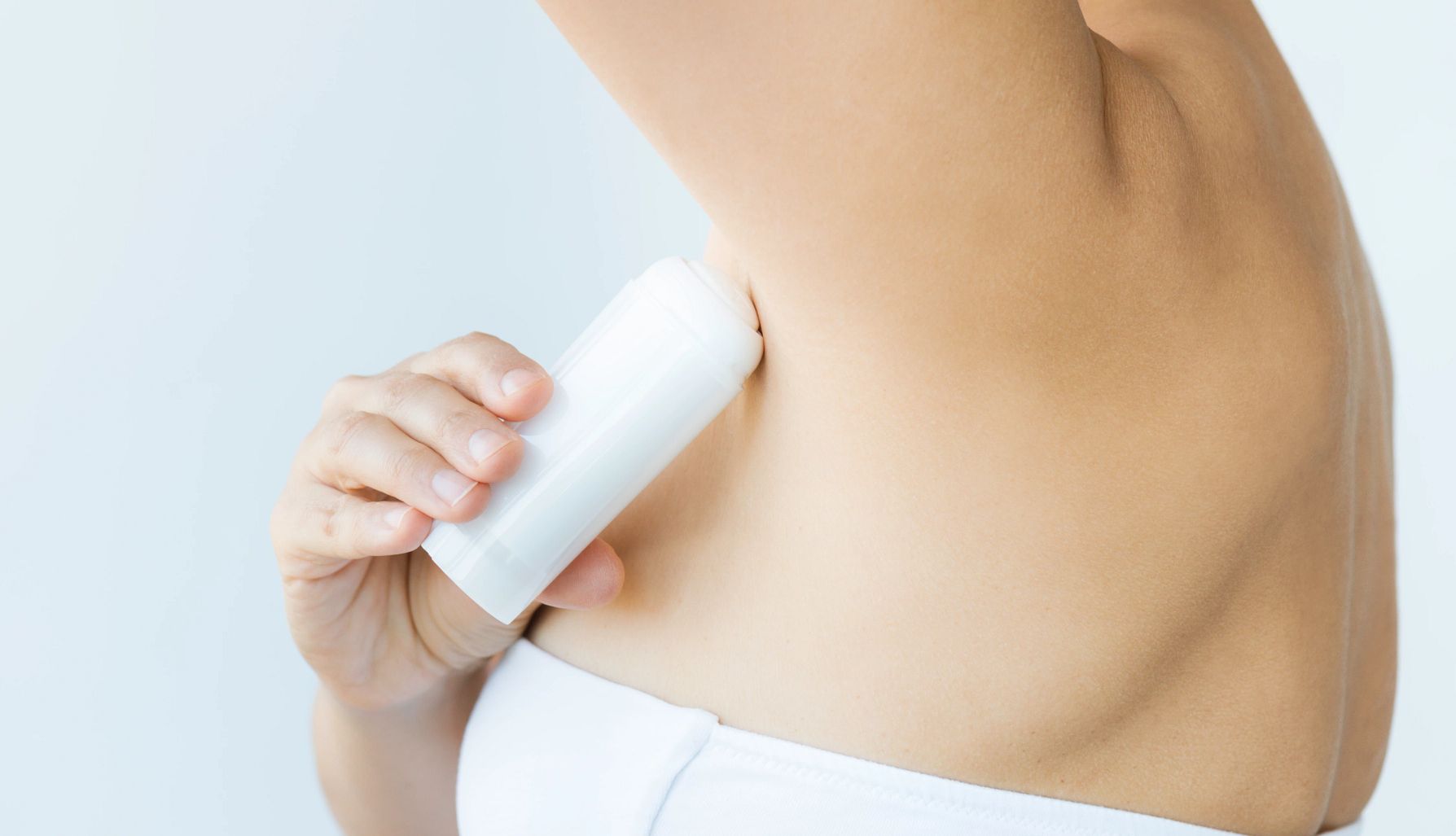 Deodorant Recall A photo shows a woman applying roll-on antiperspirant in front of white background