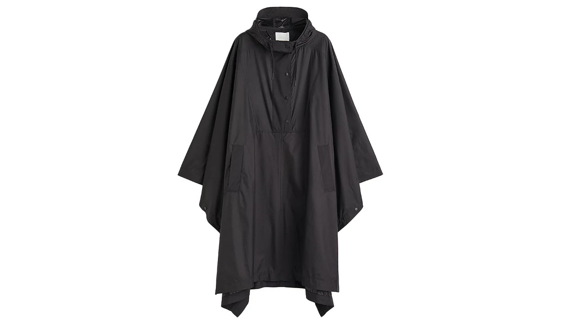 Black hooded rain poncho with snap buttons and front pockets displayed on a white background
