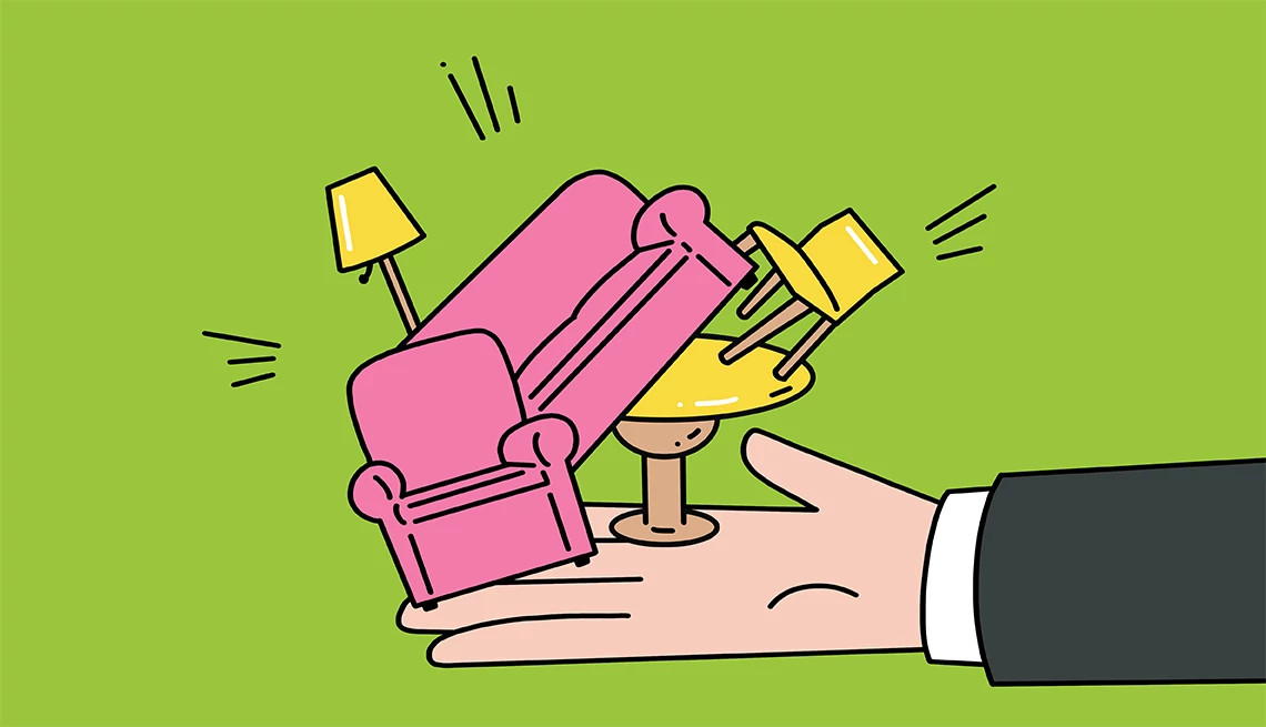 an outstretched hand holds a miniature table and chairs