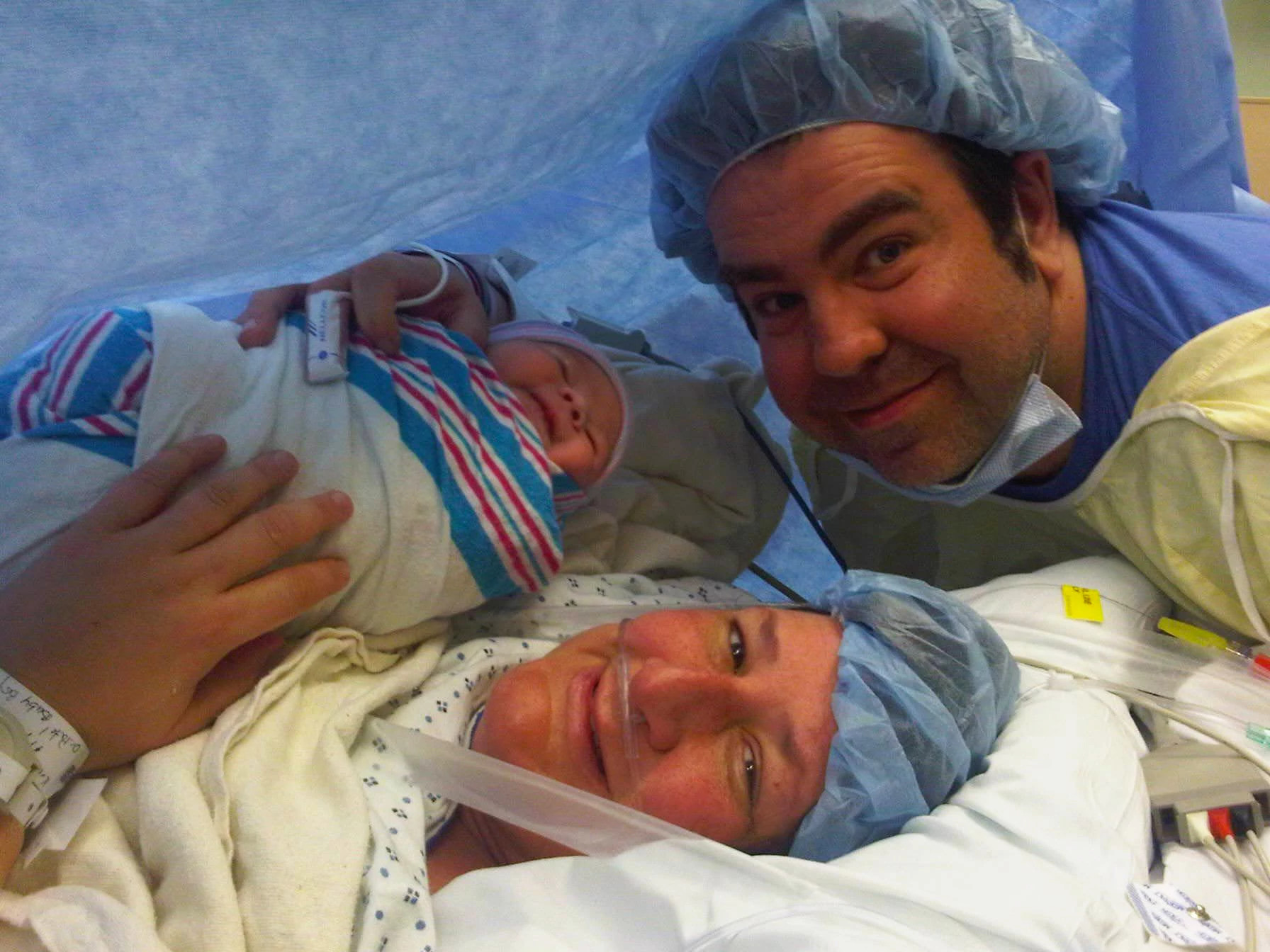 a photo shows author Eric Spitznagel and his wife with their newborn son