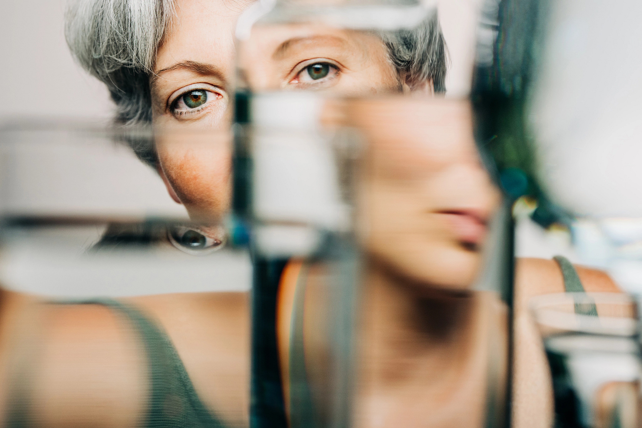 A portrait of a woman through a glass of water