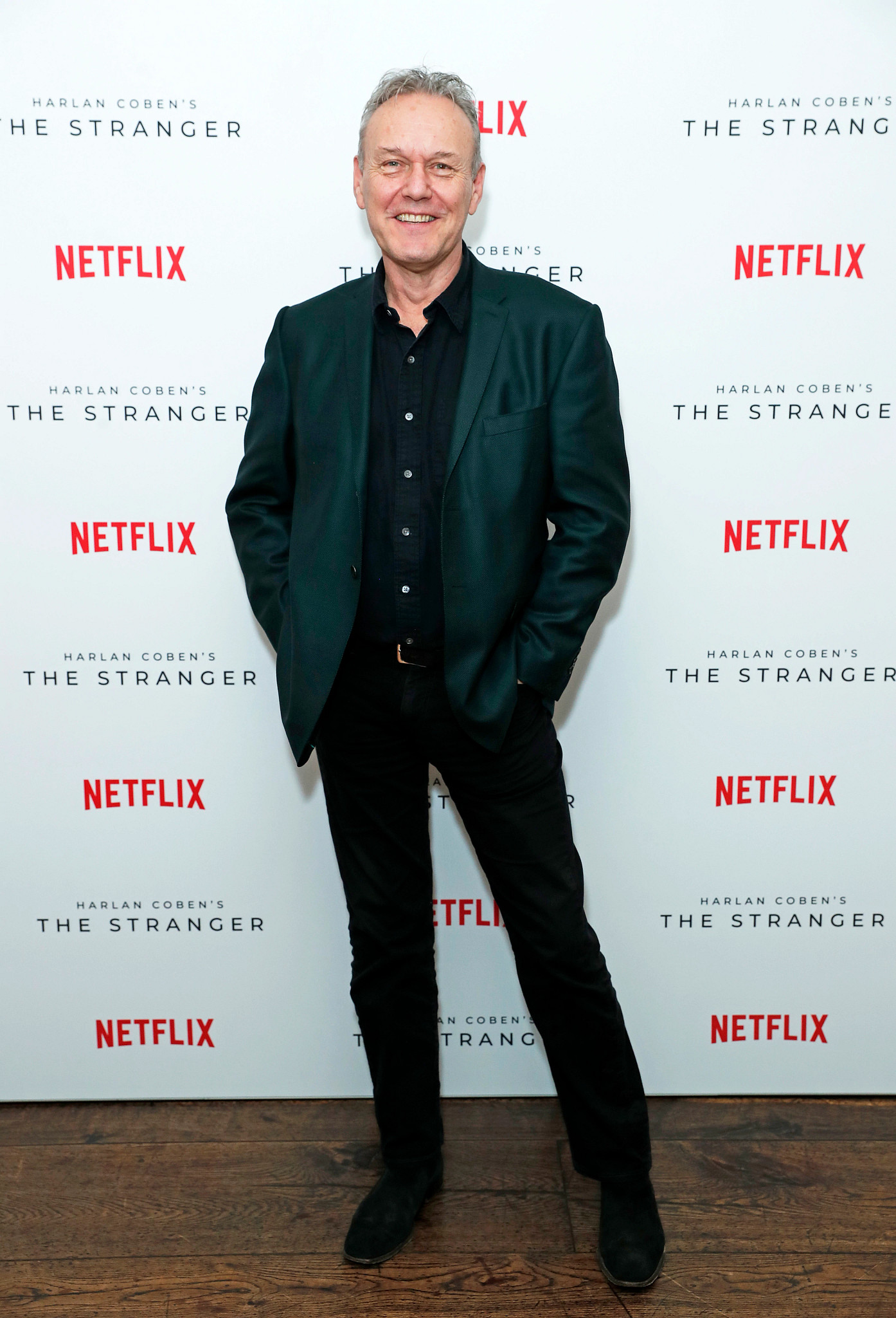 a head shot of anthony head smiling on the red carpet