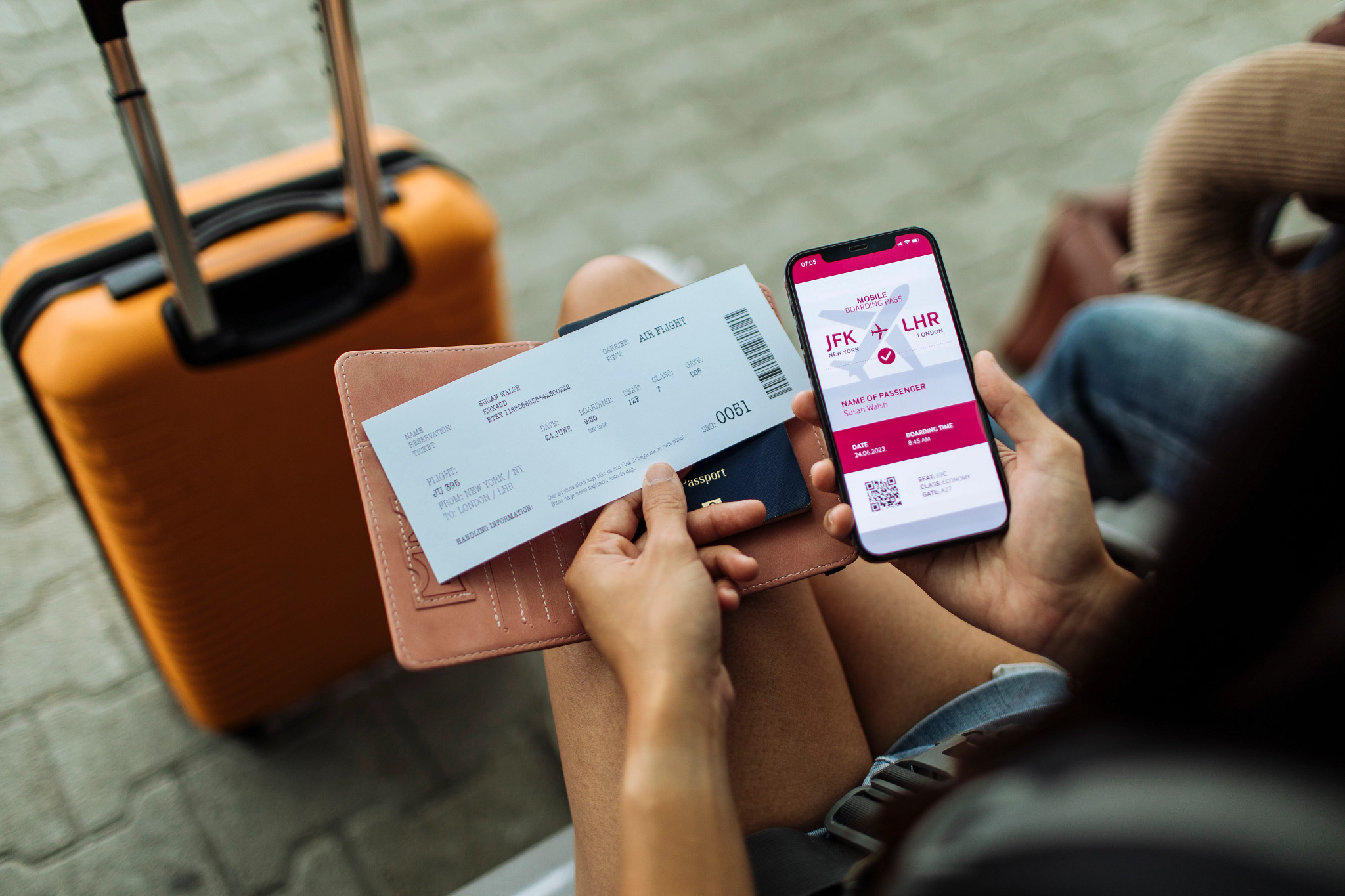 a person looking at a boarding pass and flight information on their smartphone