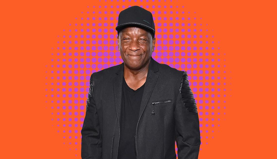 10 Songs Donnie Simpson Says You Need to Hear donnie simpson posing for a portrait in front of a colorful background