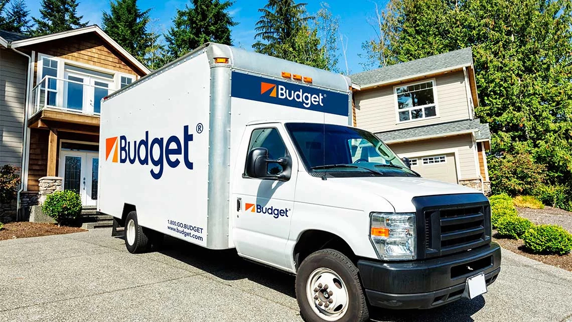 Budget Truck Rental truck in home driveway backed up to front door