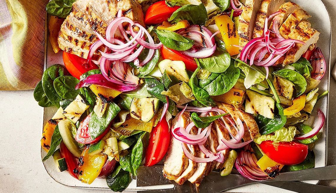 High-protein grilled chicken salad A close-up view of a high-protein grilled chicken salad on a plate