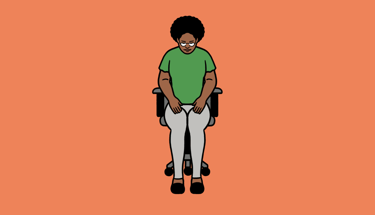 A person sits in a desk chair, moving their legs out to the side while pushing against the movement.