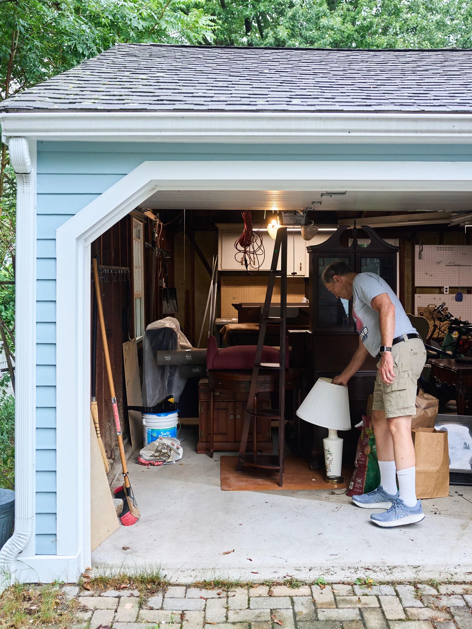 Can This Couple Find Familial Bliss Across the Country? a man going through items in his garage