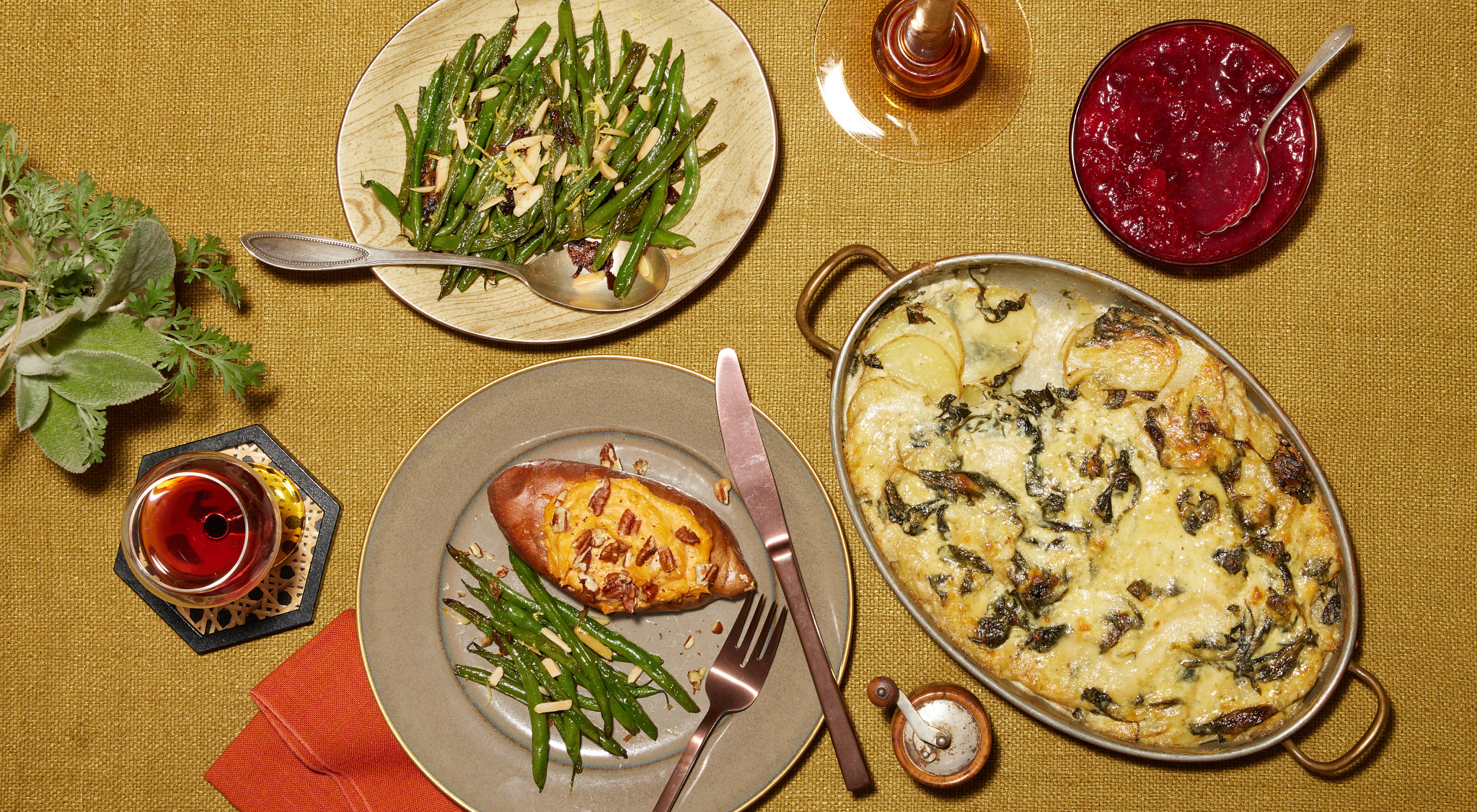 Thanksgiving side dishes including sweet potatoes, green beans, potato gratin and cranberry sauce