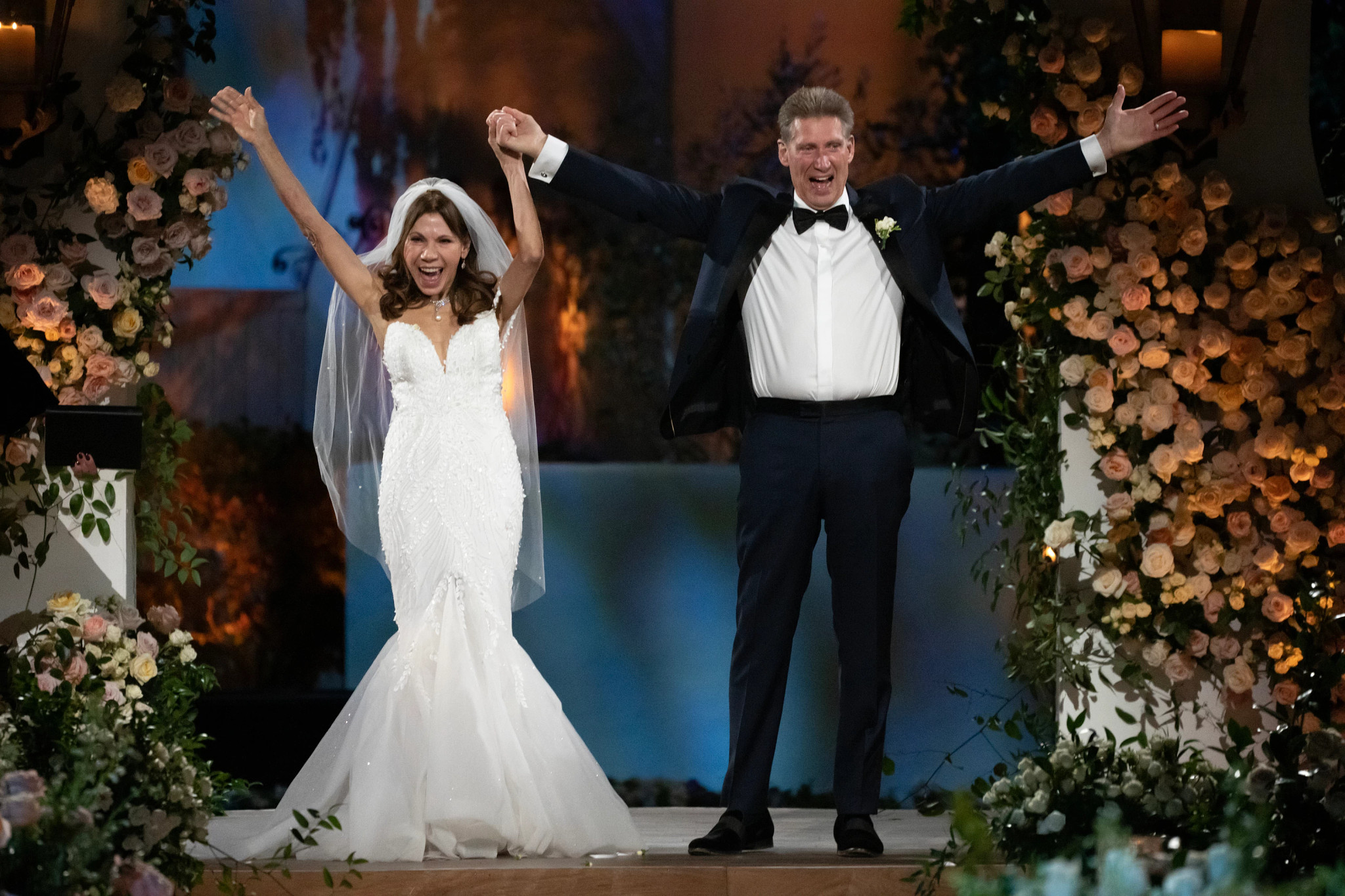 The Golden Bachelor couple Gerry Turner and Theresa Nist raise their arms in the air after getting married