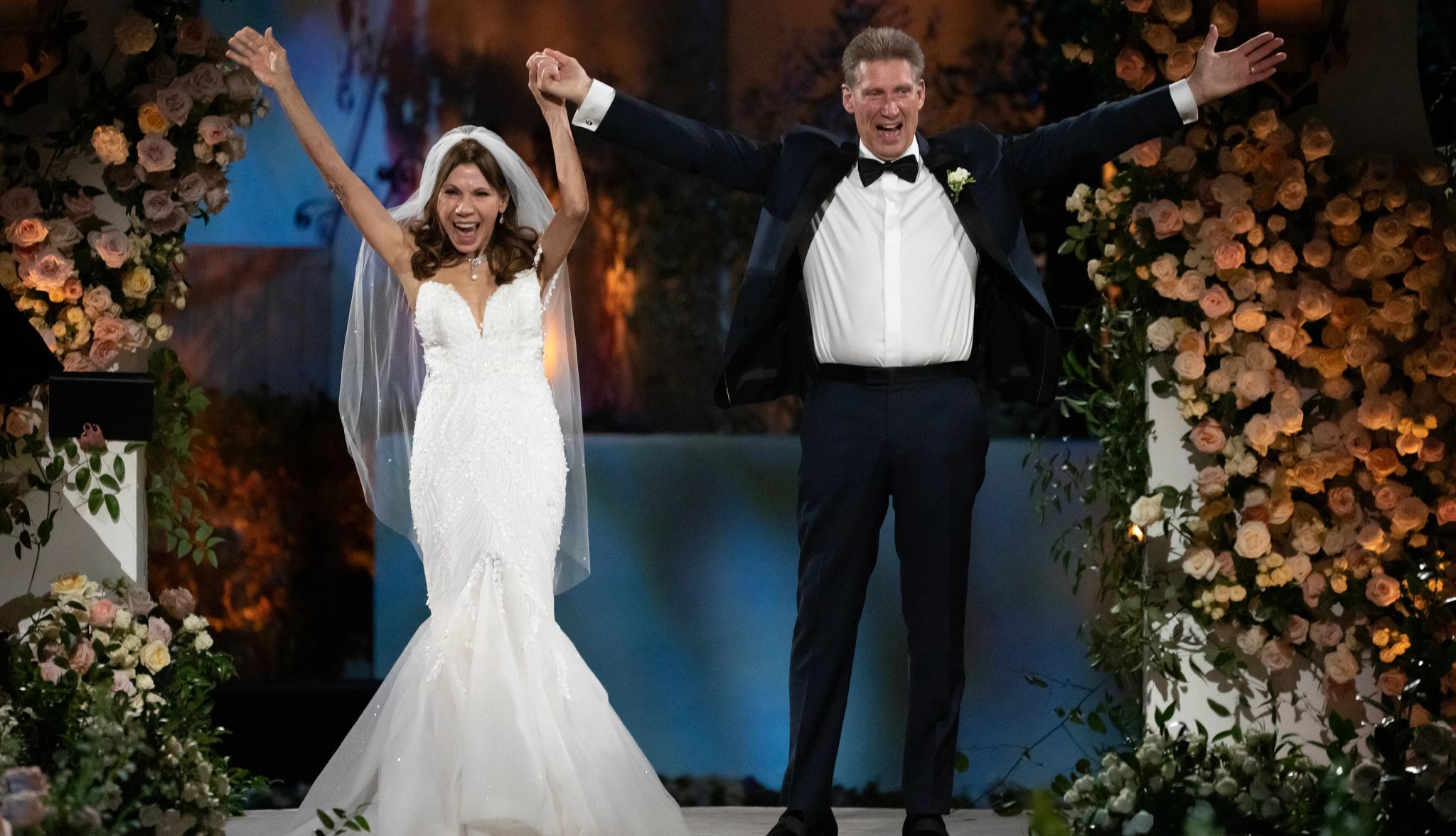 The Golden Bachelor couple Gerry Turner and Theresa Nist raise their arms in the air after getting married