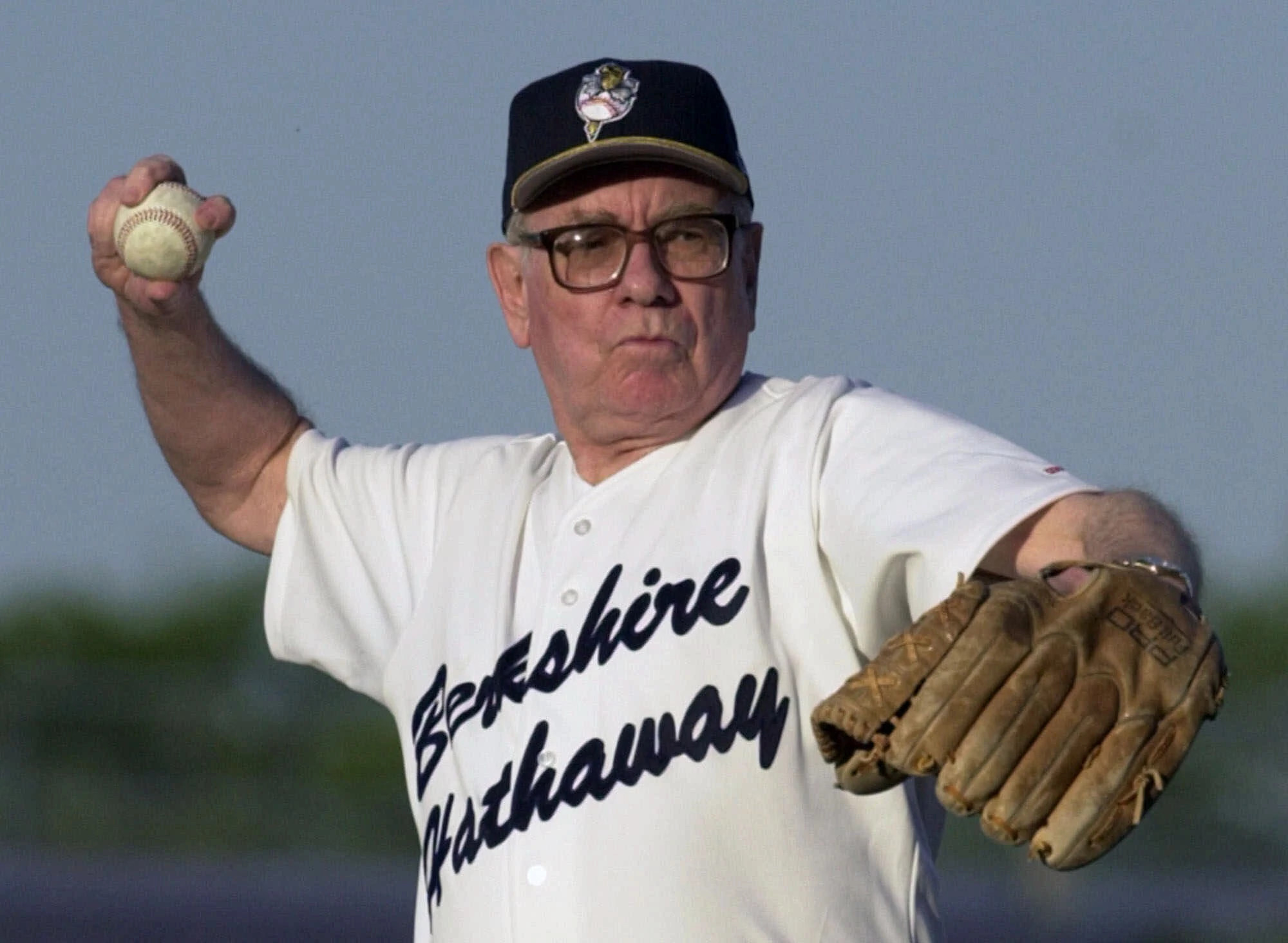 Warren Buffet pitching a baseball