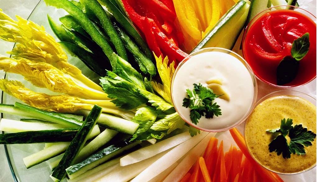 Dips can help flavor your vegetables Crudités and three dips on a glass plate
