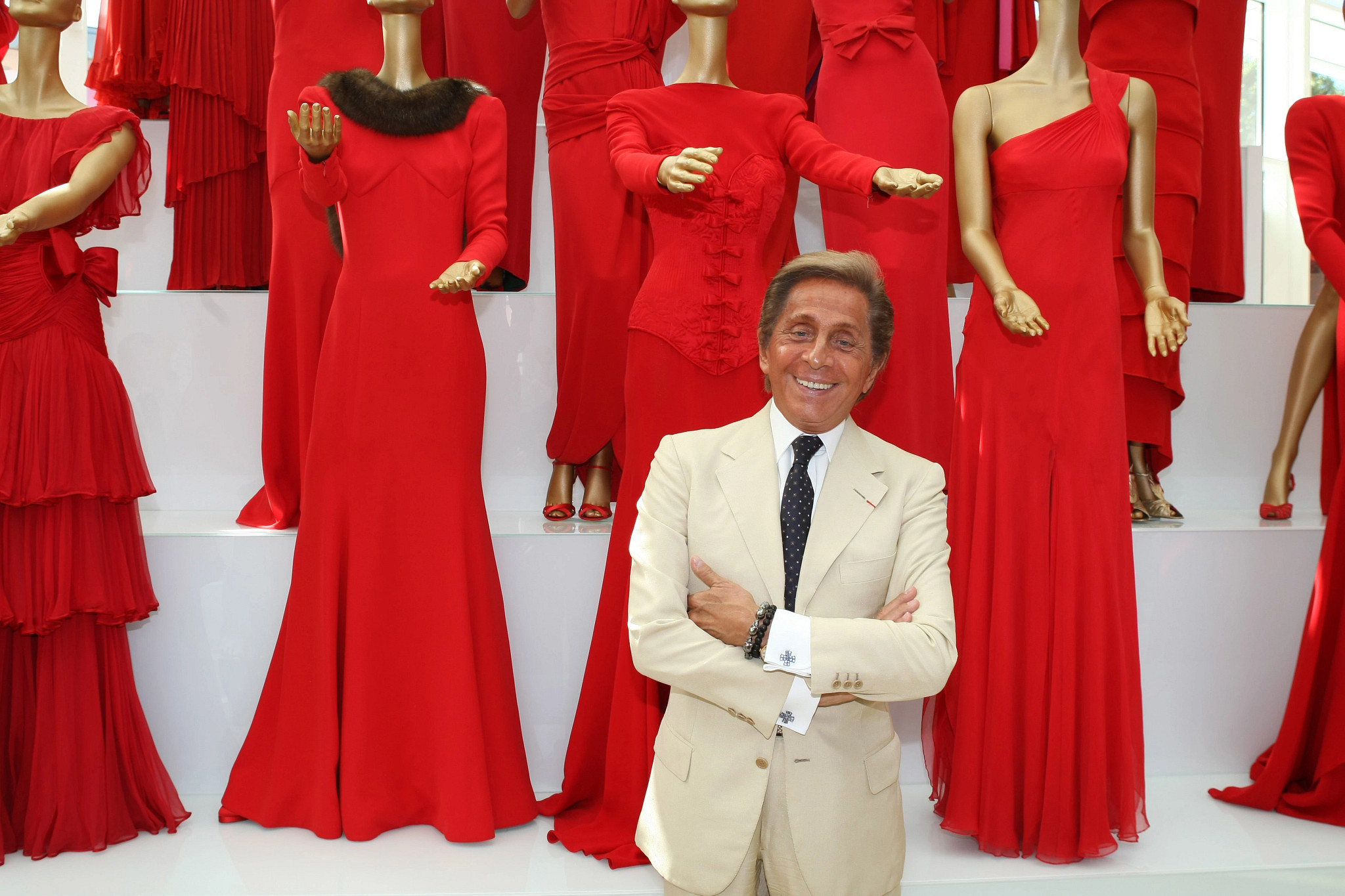 valentino with a collection of red dresses