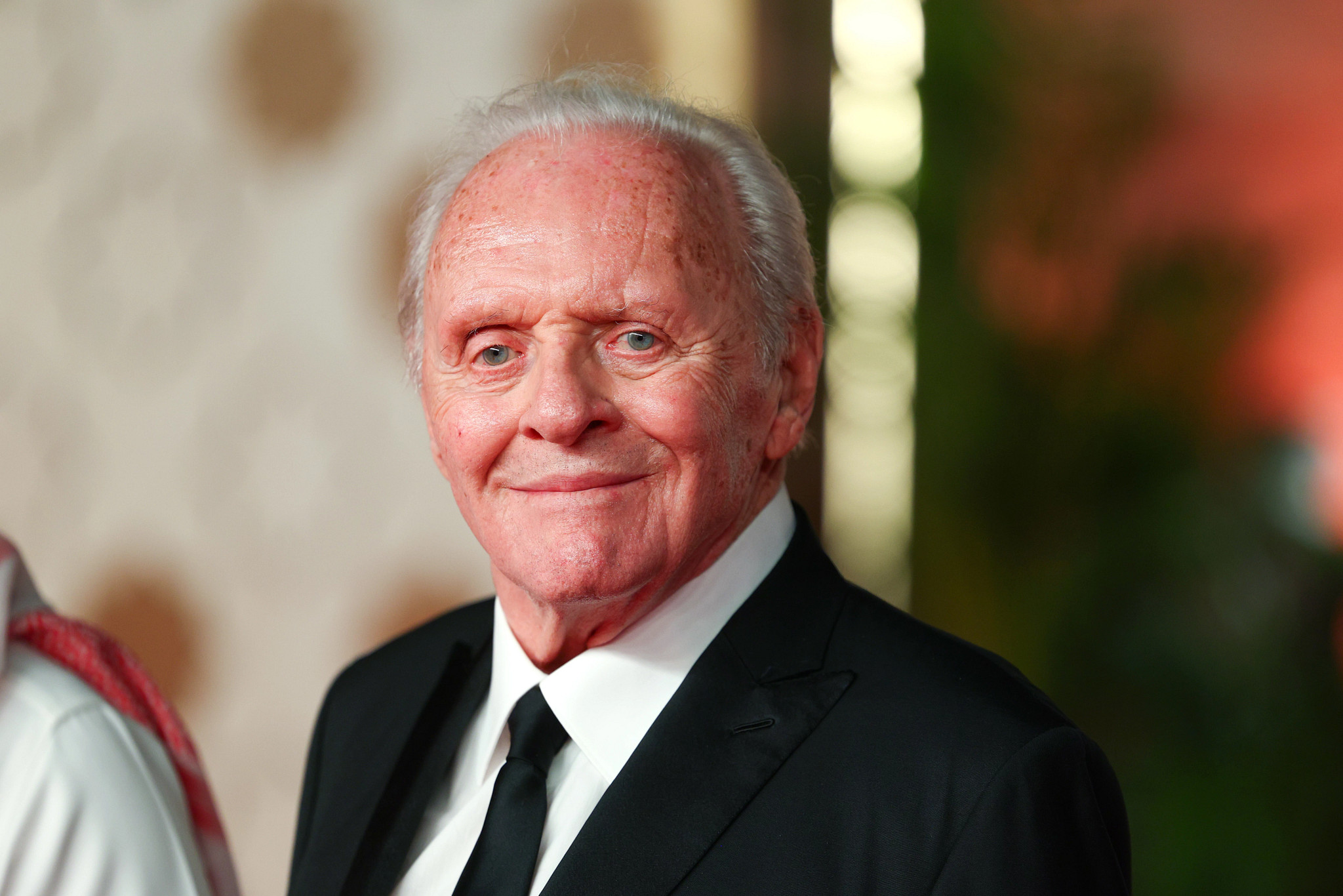 anthony hopkins in a white shirt, black tie and black suit jacket