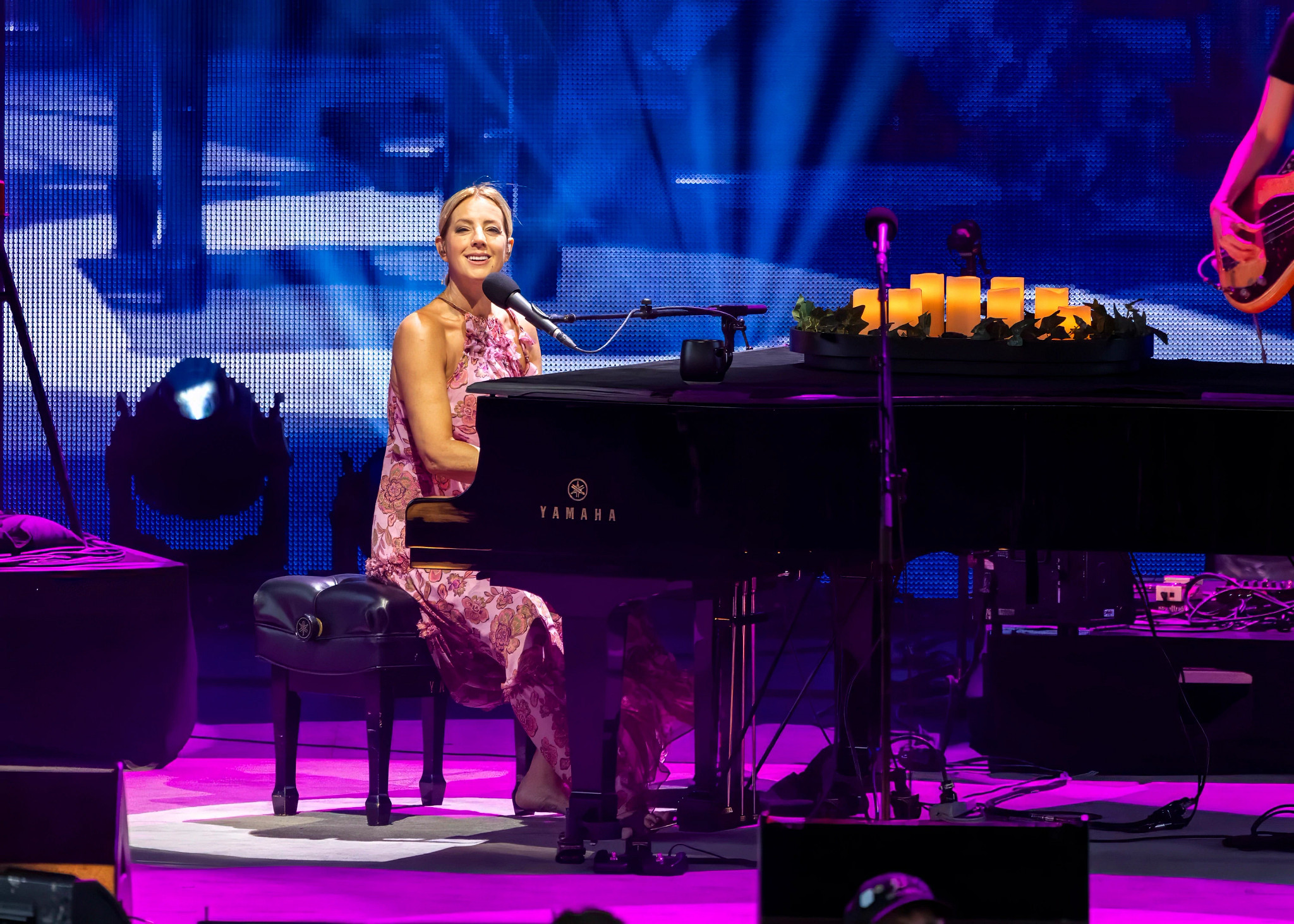 sarah mclachlan playing a piano onstage