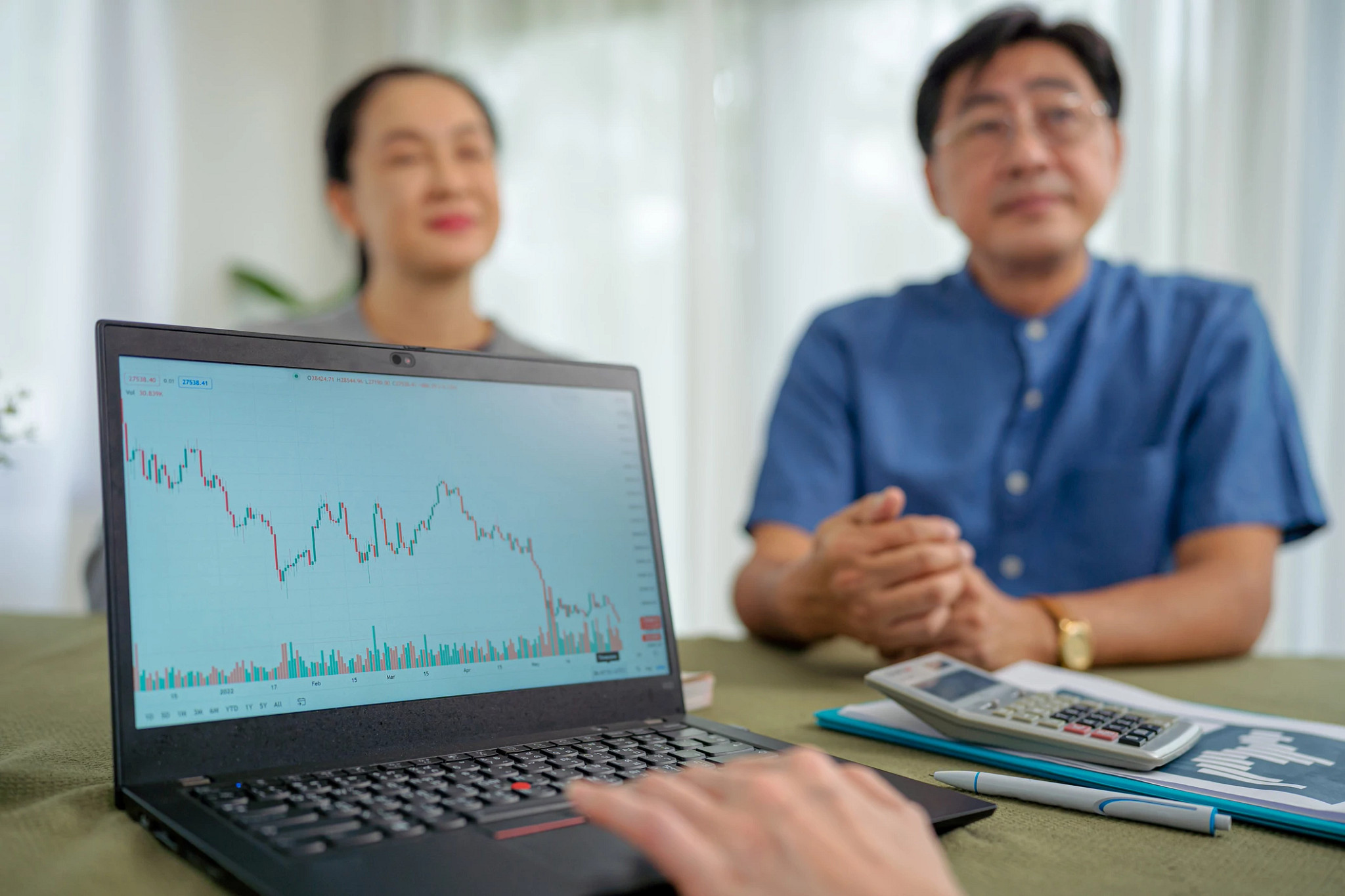 Senior couple meeting with financial consultant at home.