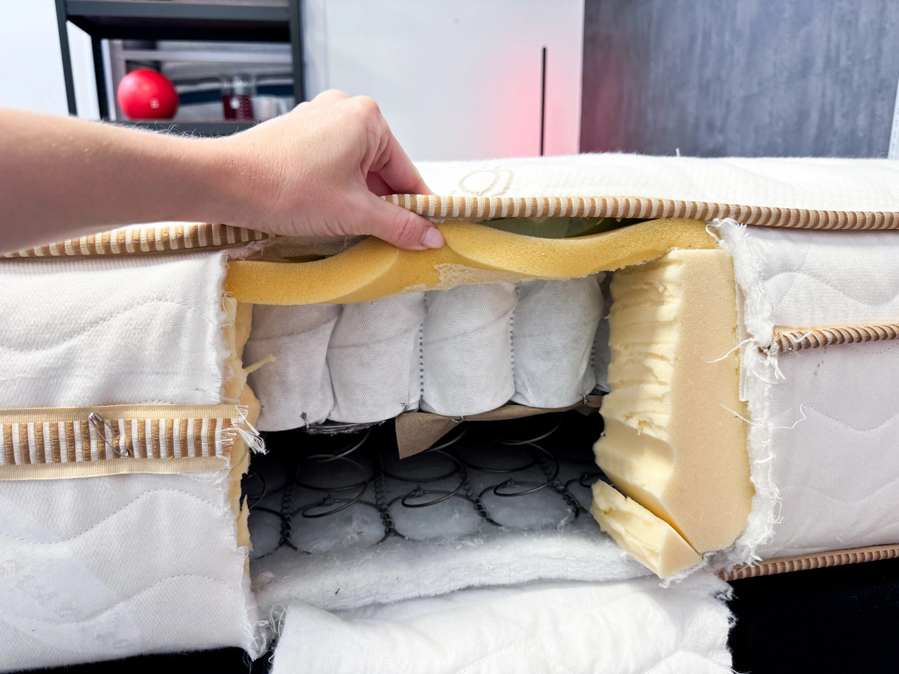 The cut-open side of a mattress revealing the coils and foam inside