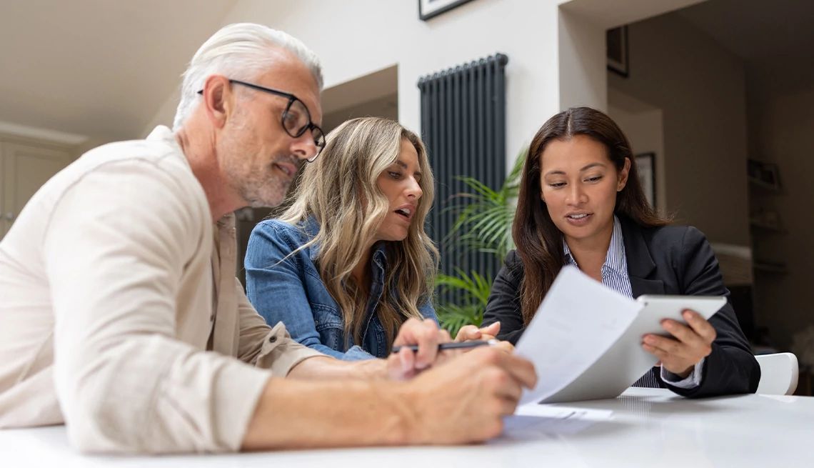 Couple looking at documents during a meeting with their financial advisor