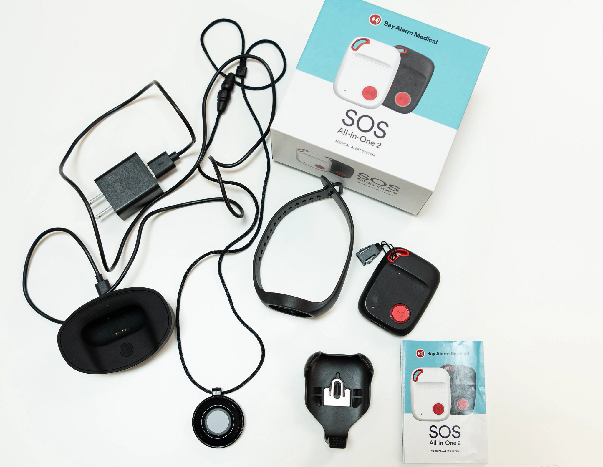The Bay Alarm Medical SOS All-in-One 2 on a table with the packaging around it